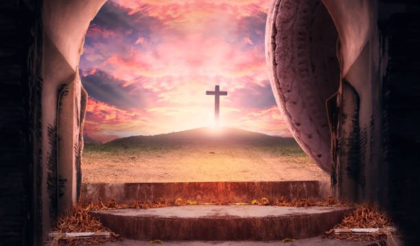 Easter Sunday concept: Tomb empty with cross on sunset background